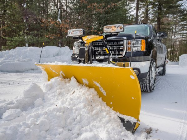 Pickup truck plowing snow during New England winter
